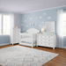 Appleseed Rowan 3-piece nursery set in white with arch top crib, double dresser, and tall chest in a bright nursery