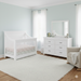 Appleseed Rowan 2-piece nursery set in White featuring a flat convertible crib and matching dresser in a bright nursery