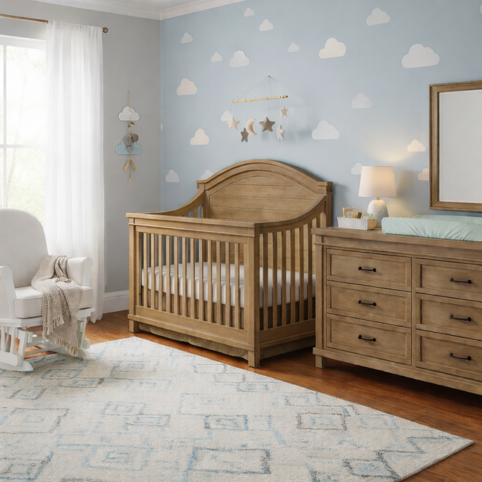 Appleseed Rowan Arch crib and dresser nursery set in sandwash wood finish, styled in a warm nursery room